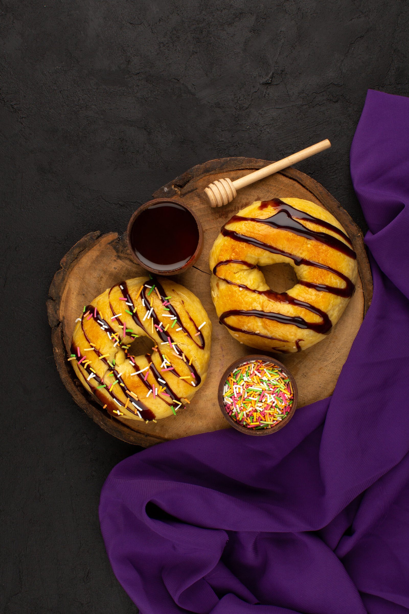 top-view-donuts-delicious-yummy-with-chocolate-brown-desk-around-purple-tissue-dark